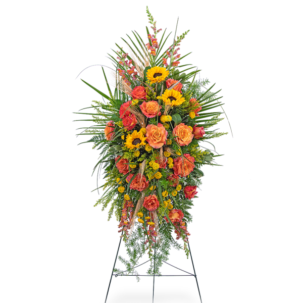 Tall standing spray with orange roses and yellow sunflowers on an easel