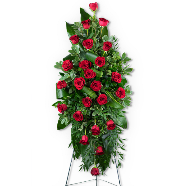 Tall standing spray of red roses and greenery on an easel
