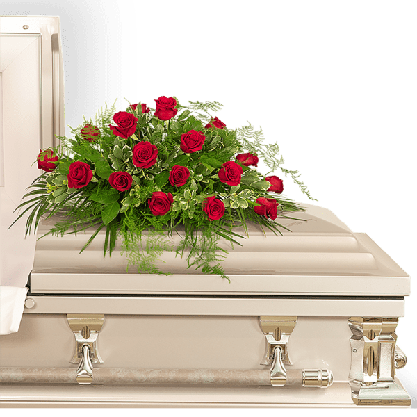 Red rose arrangement on a white casket