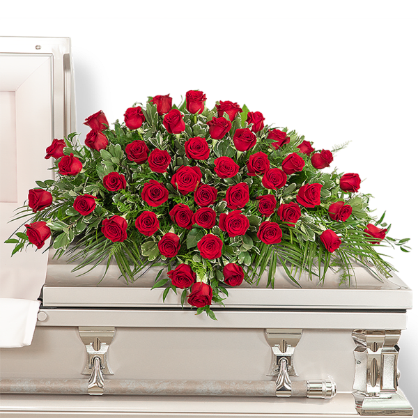 Red rose casket spray on a white casket