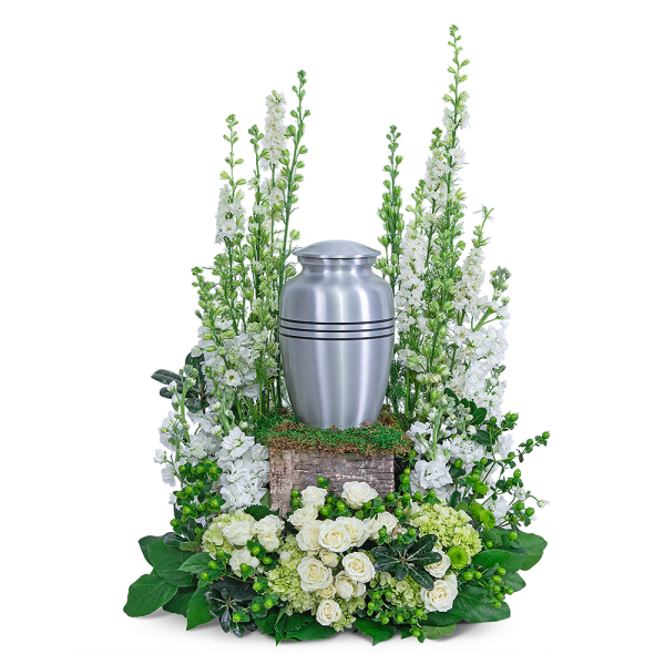 White floral funeral urn arrangement with a silver urn centerpiece