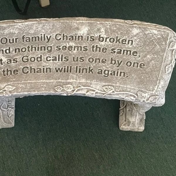 Stone memorial plaque with an engraved family remembrance message