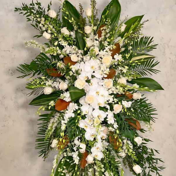 Large white floral standing spray with orchids and roses