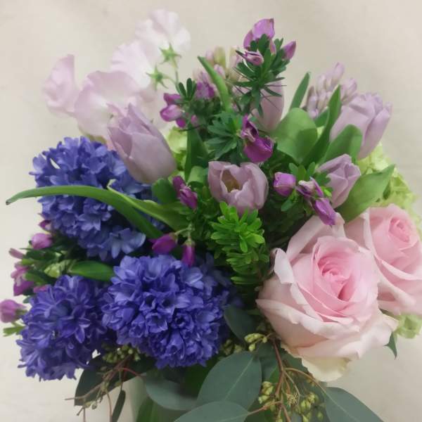 Bouquet of pink roses, purple hyacinths, and lavender tulips