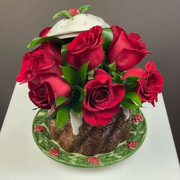 Bouquet of red roses arranged in a decorative cake-shaped container
