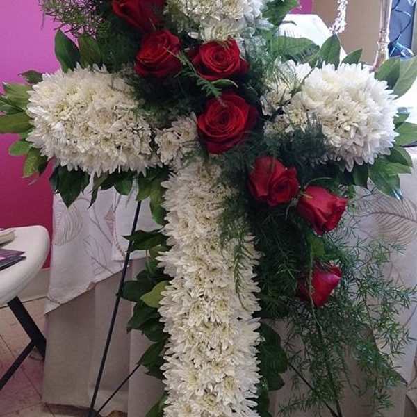 Cross-shaped floral spray with white chrysanthemums and red roses