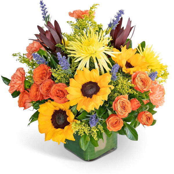 Bright mixed bouquet with sunflowers, orange roses, and purple accents in a square vase