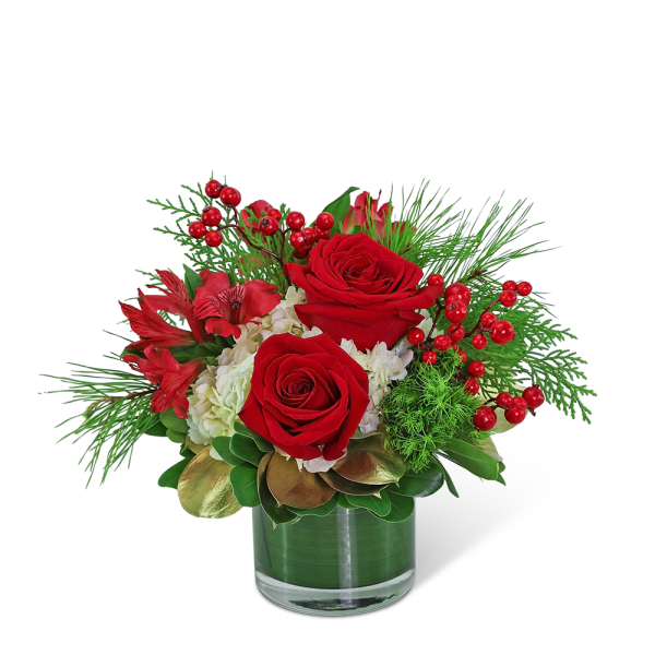 Red roses and red flowers in a glass vase with berries
