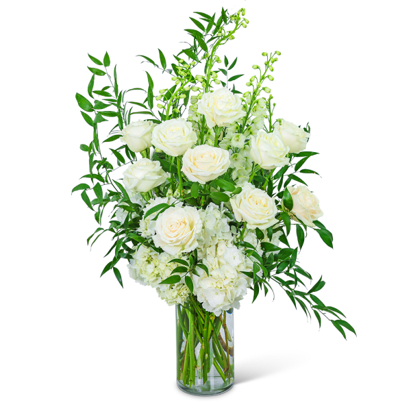 White roses and hydrangeas in a clear glass vase