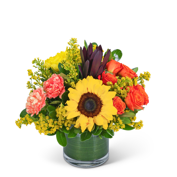 Sunflower and orange rose bouquet in a glass vase