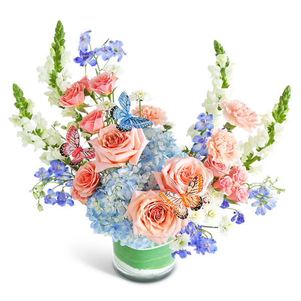 Peach roses and blue hydrangeas in a glass vase with butterfly accents