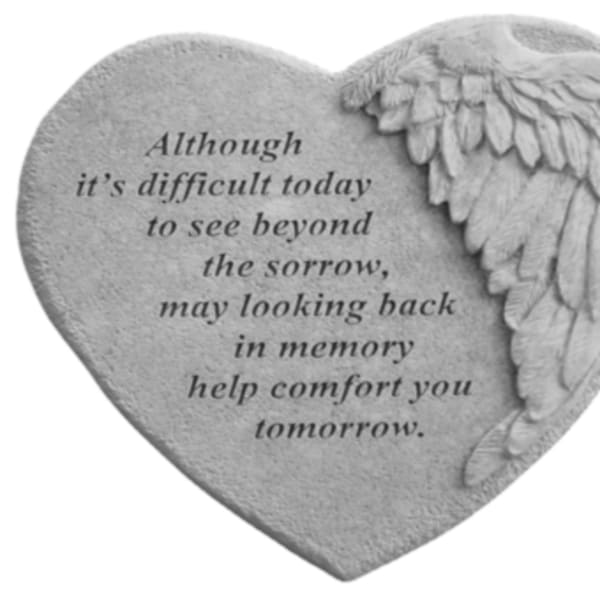 Heart-shaped memorial stone with engraved text and angel wings