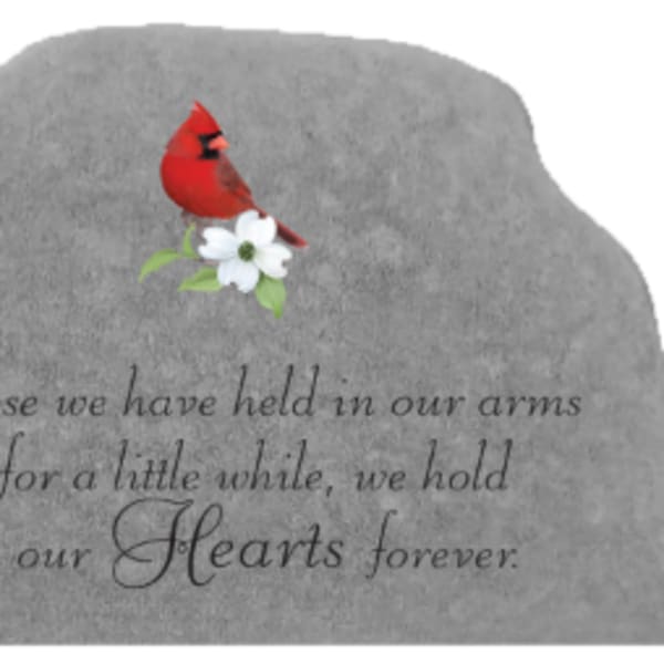 Gray memorial stone with a red cardinal and white flower engraving