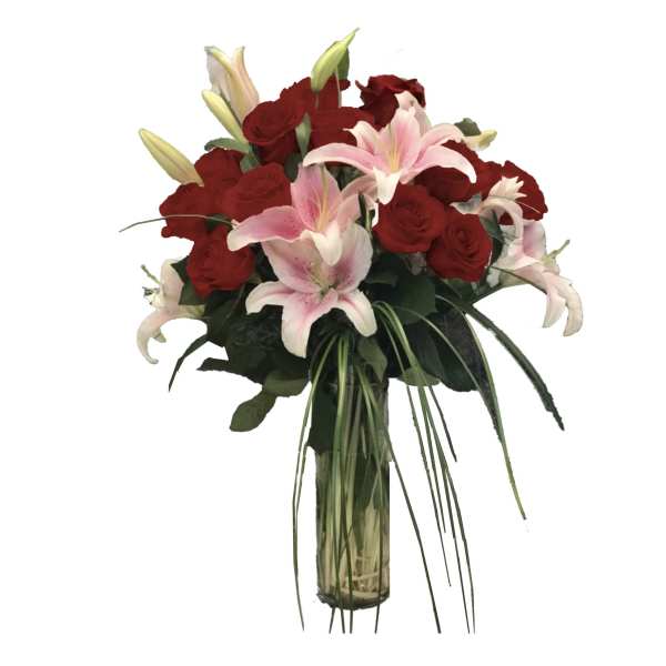 Tall glass vase arrangement of red roses and pink lilies with white lily buds