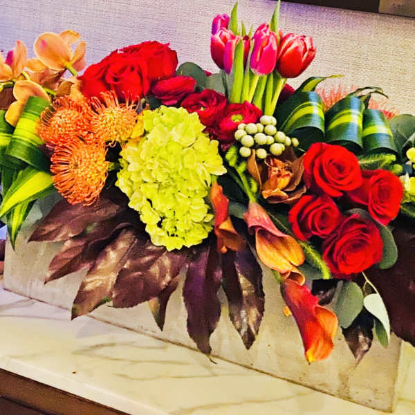 Colorful mixed floral arrangement in a rectangular container