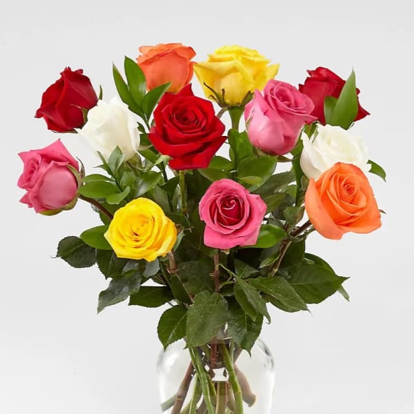 Bouquet of multicolored roses in a clear glass vase