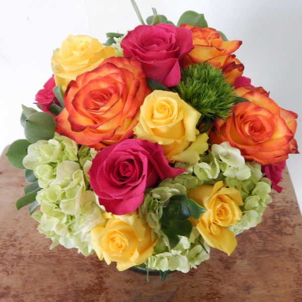 Bouquet of multicolored roses with pale hydrangeas
