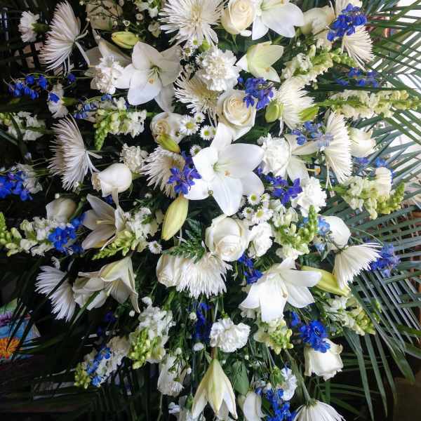 Large white and blue floral spray with lilies and roses