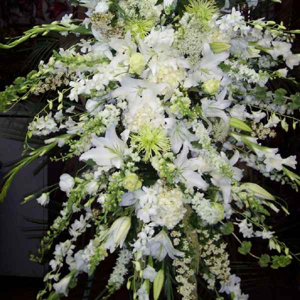 Large white floral spray with lilies and orchids