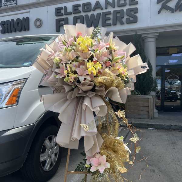 Large pastel bouquet with lilies and orchids on a stand