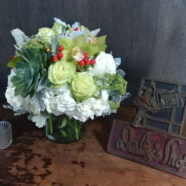 Mixed bouquet in a glass vase with white and green flowers