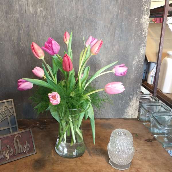Pink and purple tulips in a clear glass vase