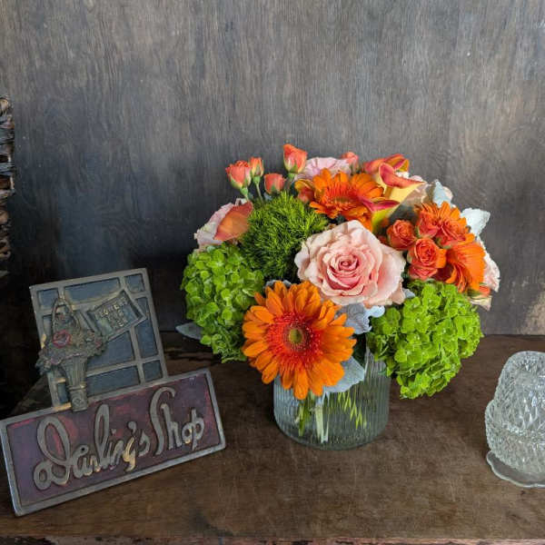 Bouquet of orange and pink flowers in a glass vase