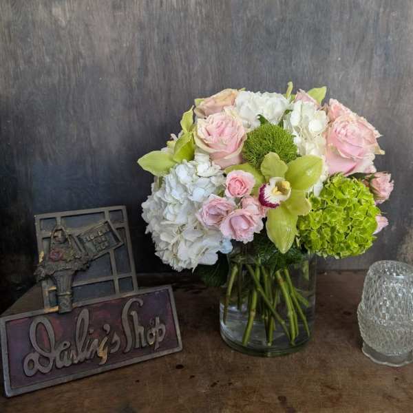 Pink and white flower arrangement in a glass vase