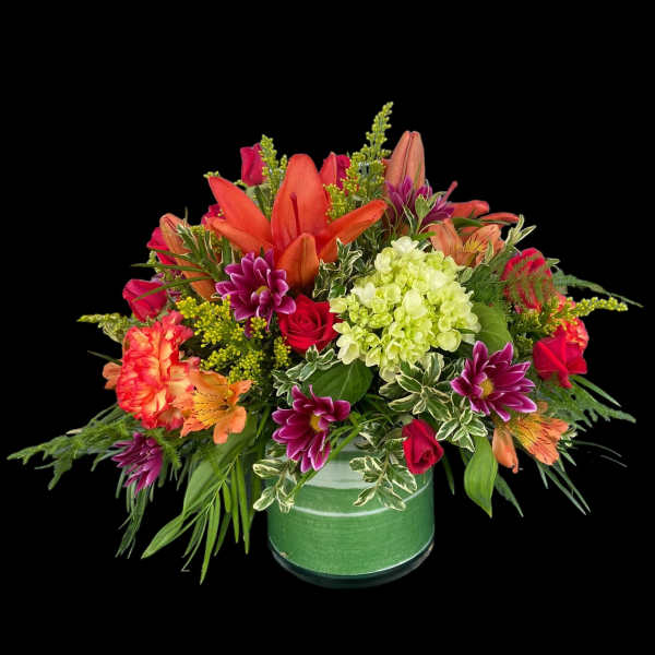 Colorful mixed flower arrangement in a green vase