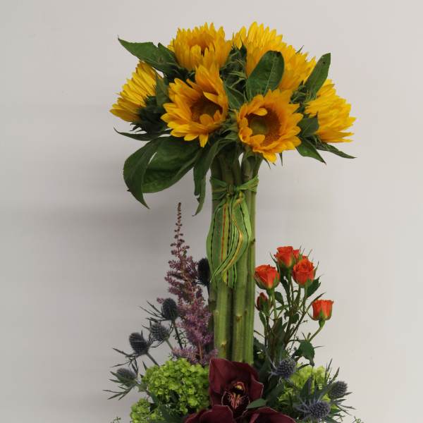 Tall sunflower arrangement with orchids and roses in a rustic wood box with ladybug accents