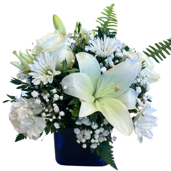 White lilies and roses arranged in a dark blue vase