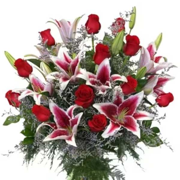 Bouquet of red roses and pink lilies in a glass vase