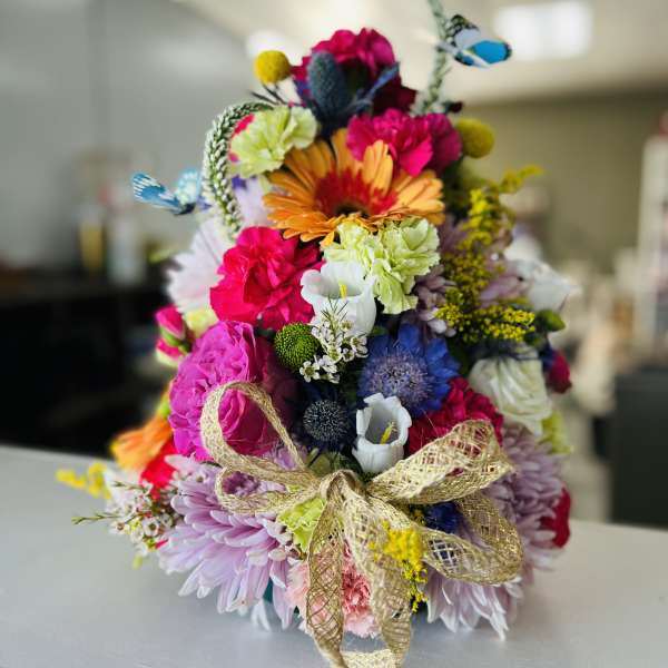 Colorful mixed bouquet with a gold ribbon bow