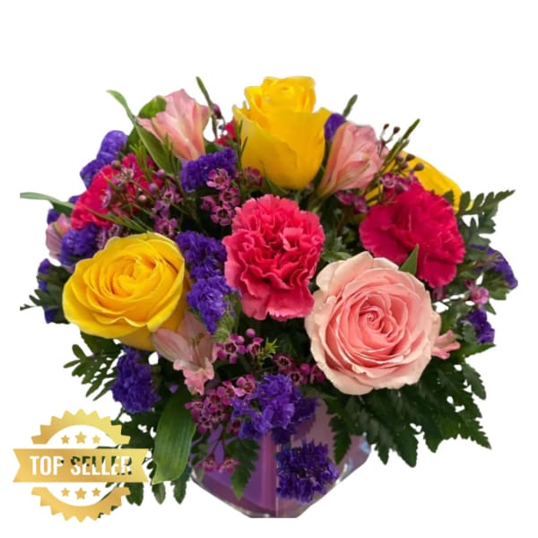 Mixed bouquet with yellow and pink roses, carnations, and purple filler flowers