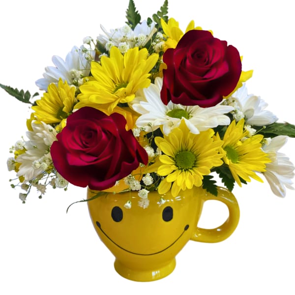 Yellow smiley-face mug holding red roses and white-yellow daisies