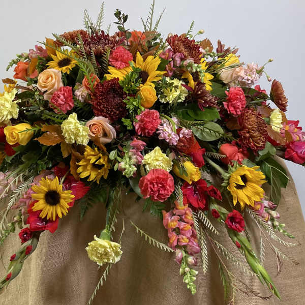 Large mixed floral arrangement with sunflowers, roses, and carnations