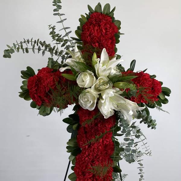 Red and white floral cross on a stand