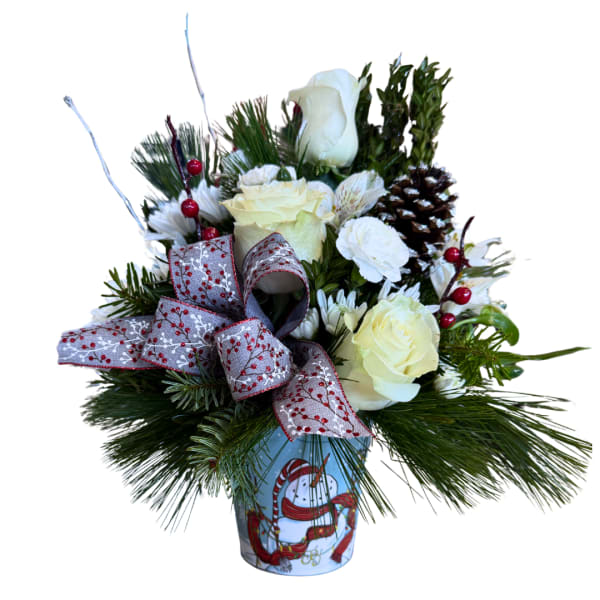 Holiday floral arrangement with white roses in a decorated tin container