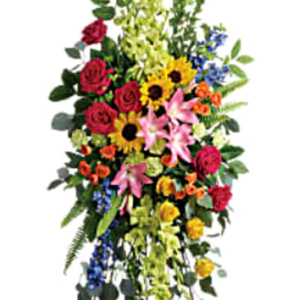 Tall standing floral spray with mixed bright flowers on an easel