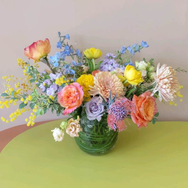 Mixed bouquet of colorful flowers in a glass vase