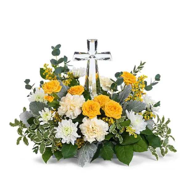 Yellow and white floral arrangement with a clear glass cross centerpiece