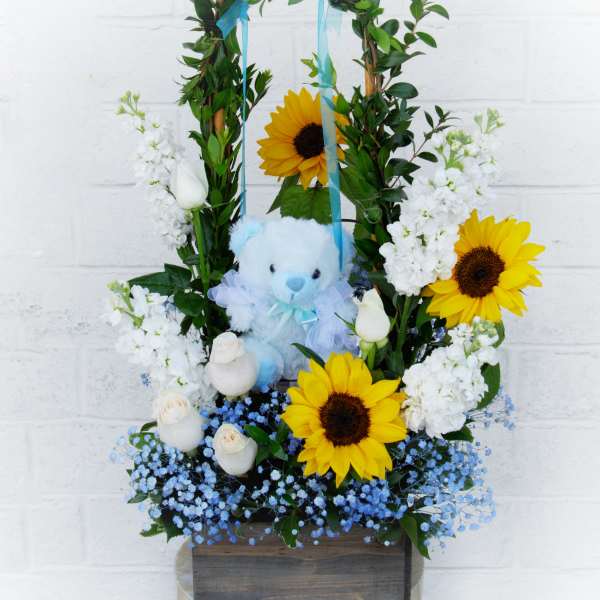 Sunflower and white rose arrangement with a blue teddy bear in a wooden box