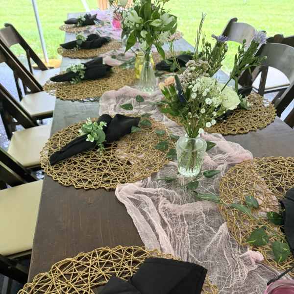 Floral table centerpiece with small mixed bouquets in glass jars