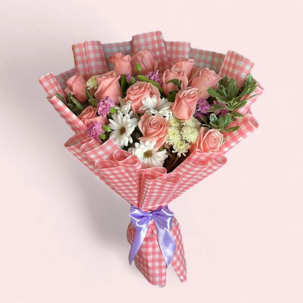 Pink rose bouquet with white daisies in checkered wrap and purple ribbon