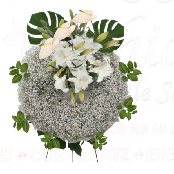 White floral wreath with lilies and baby’s breath