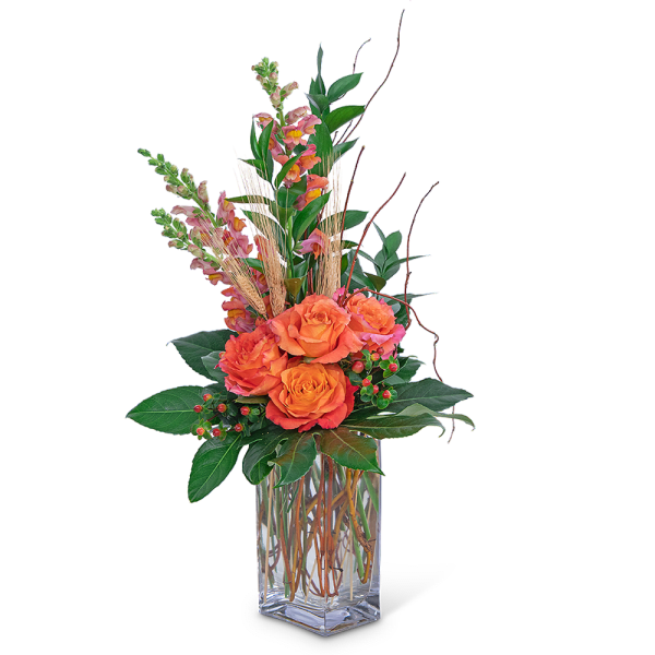 Orange roses in a clear glass vase with tall pink snapdragons