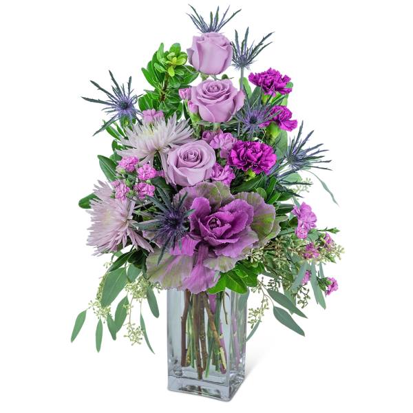 Lavender roses and purple flowers in a clear glass vase