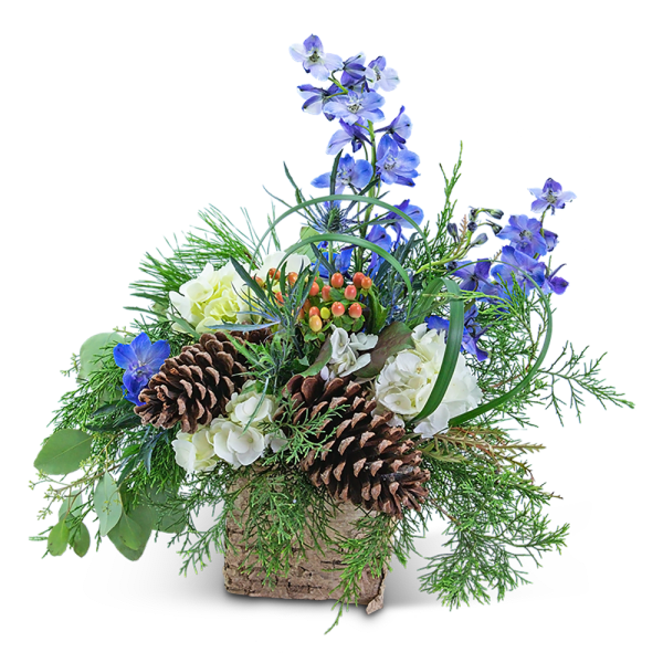 Blue flowers and white blooms in a rustic basket with pinecones