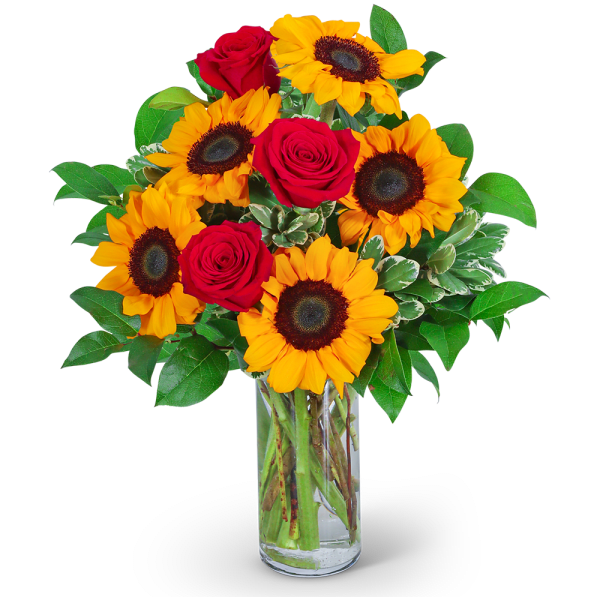 Bouquet of red roses and yellow sunflowers in a clear glass vase