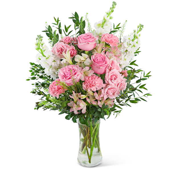 Pink roses and white flowers arranged in a clear glass vase